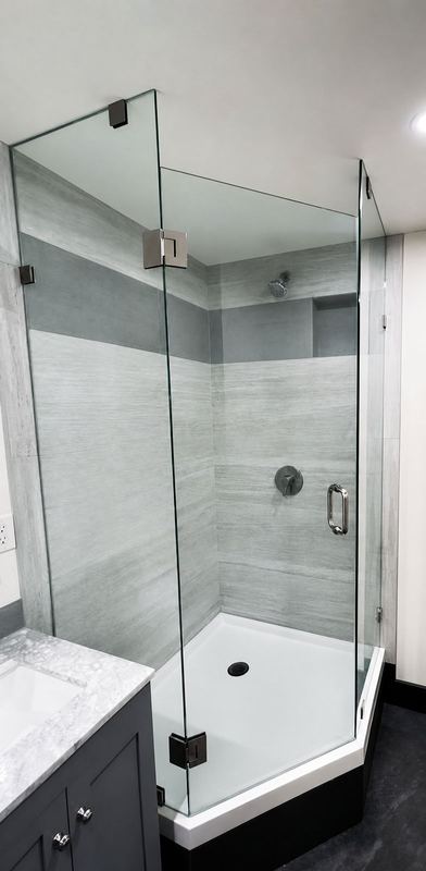 Neo-angle frameless glass shower enclosure by Shower Enclosures by George