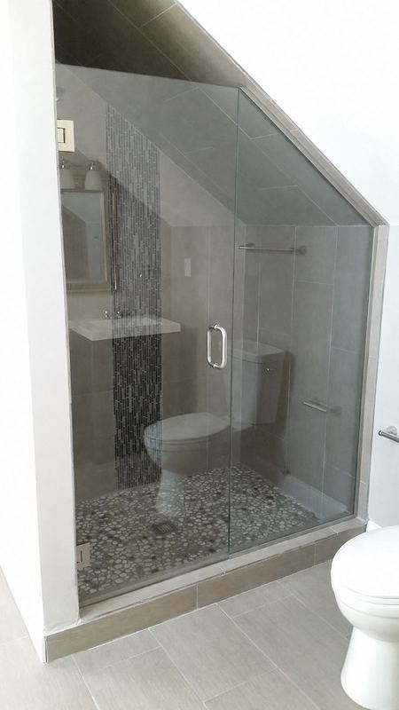 Sloped-ceiling frameless glass shower enclosure by Shower Enclosures by George